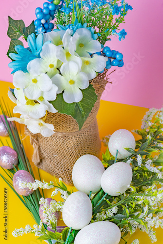 white flowers and blue flowers with two egg bouquets on purple and gold background