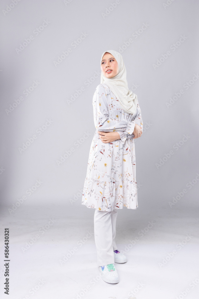 Young smiling confident asian muslim woman in hijab over isolated over background studio. Casual hijab fashion. Young smiling confident asian muslim woman in hijab over isolated over background studio. Casual hijab fashion.