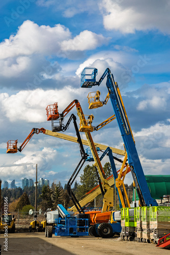 Wallpaper Mural Construction machinery for rent. Lifts with raised platforms and are at the industrial court yard Torontodigital.ca
