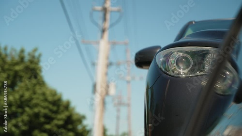 unique view of a car hauled by a wedge car trailers-carhauling. With small reflection in the window. Trailer is pulled by a pickup truck. Similar view as tow truck photo