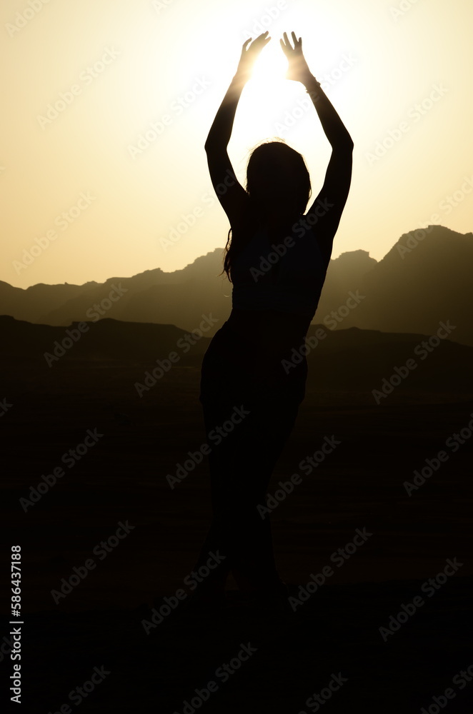 Silhouette of a girl against the sunset Silhouette of a girl against the sunset