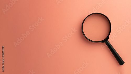 Принти на полотні Photo of magnifying glass on right side over pink pastel background with copyspace for put your text or logo