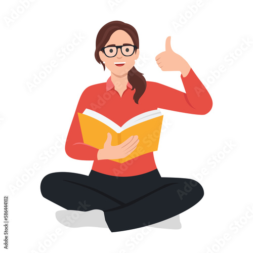 Education process and positive emotions concept. Smiling girl student sitting on floor reading book showing thumbs up sign with fingers