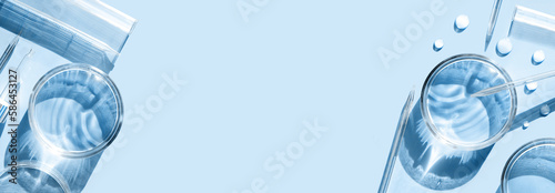 serum in petri dishes on light blue background cosmetic research concept