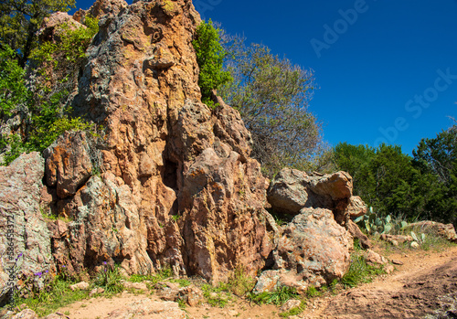 A colorful Gneiss rock formation with a footpath at a popular state park in the Texas Hill Country