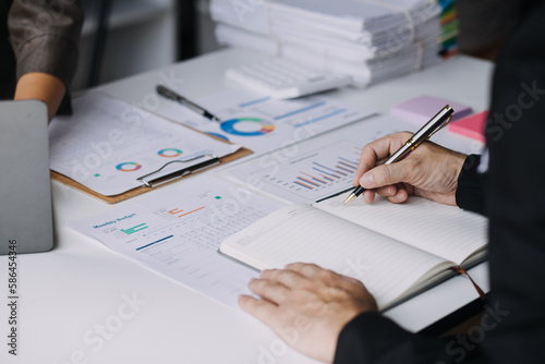 Financial analysts analyze business financial reports on a digital tablet planning investment project during a discussion at a meeting of corporate showing the results of their successful teamwork.