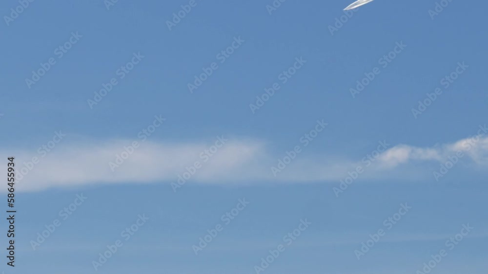 Blue Sky Static with Airplane Flying into Frame Producing Contrails. Blue Sky Static with Airplane Flying into Frame Producing Contrails.