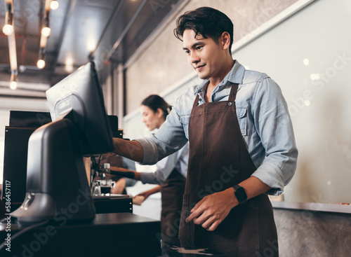 Cafe handsome Asia man waitress cashes in order bill register working happy at coffee shop
