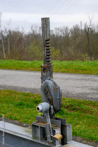 Old metal water regulator of a sluice in close-up