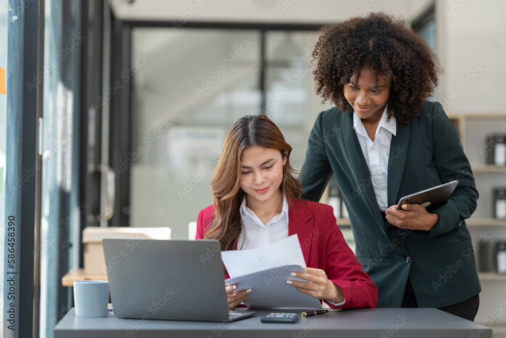 Fototapeta premium Young Asian and African businesswoman Africans brainstorming on real estate projects. investment plan Financial business together in the office management concept management.