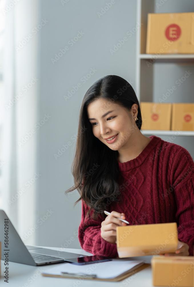 Business woman owner holding parcel box Verify the correctness in the list, address, customer phone number for parcel delivery through the express delivery company. startup business ideas. Business woman owner holding parcel box Verify the correctness in the list, address, customer phone number for parcel delivery through the express delivery company. startup business ideas.