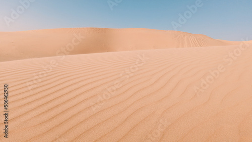 Sand dunes in the desert with a light on the top