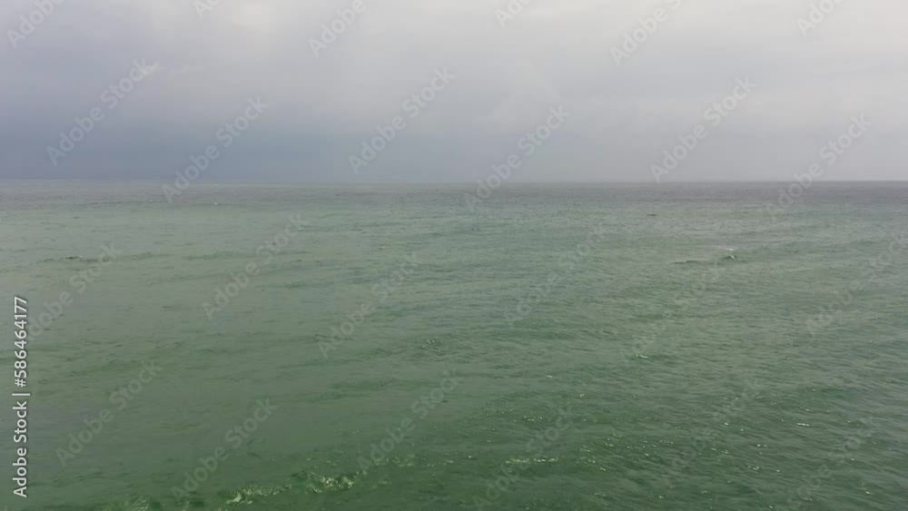 Blue ocean with waves and sky with clouds, seascape top view. Blue sea water with waves against sky. Blue ocean with waves and sky with clouds, seascape top view. Blue sea water with waves against sky.