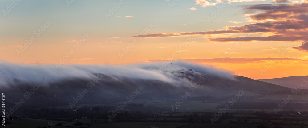 Obraz premium Low cloud and fog rolling in over Devils Dyke and the south downs from Newtimber Hill near Poynings West Sussex south east England UK