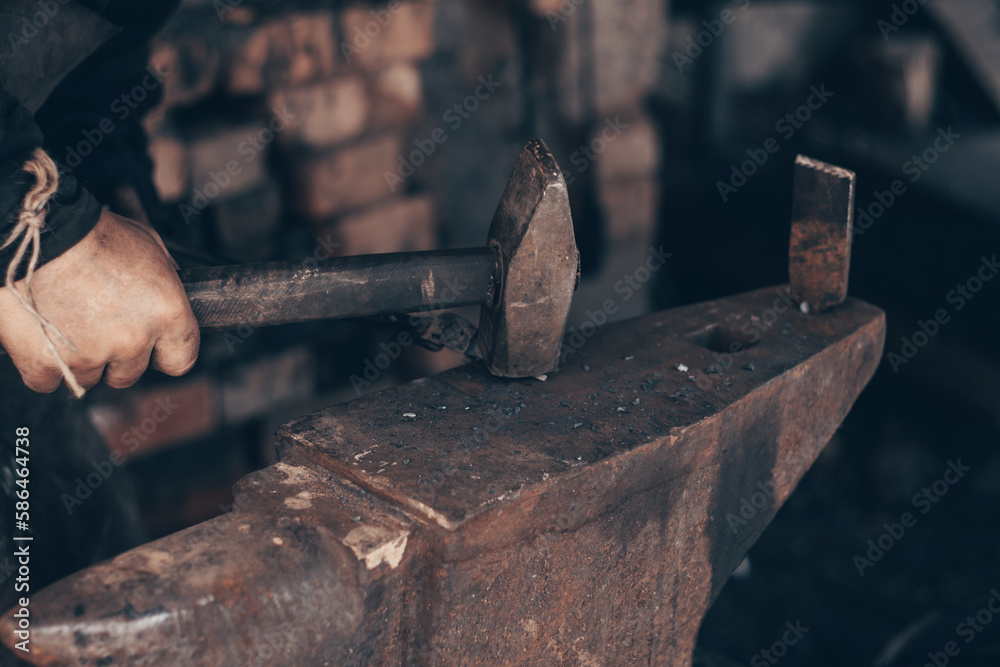 Blacksmith working metal with hammer and pincers on anvil in forge. Farrier strike iron in workshop. Metalworking, manufacturing equipment and tools. Traditional technic of making hardware. Blacksmith working metal with hammer and pincers on anvil in forge. Farrier strike iron in workshop. Metalworking, manufacturing equipment and tools. Traditional technic of making hardware.