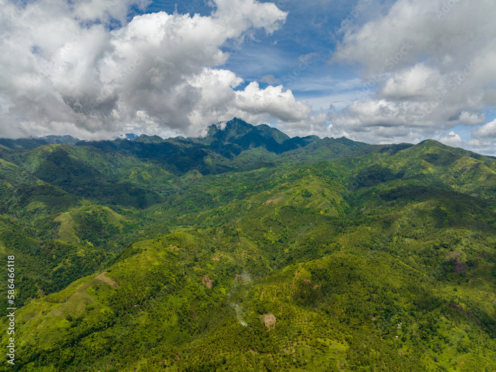 Naklejka premium Tropical mountain range and mountain slopes with rainforest. Philippines, Negros island.