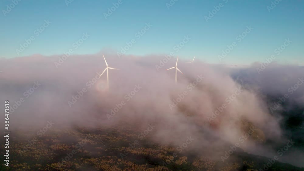 Aerial of wind turbines turning with flowing clouds underneath them, Madiera, Portugal Aerial of wind turbines turning with flowing clouds underneath them, Madiera, Portugal