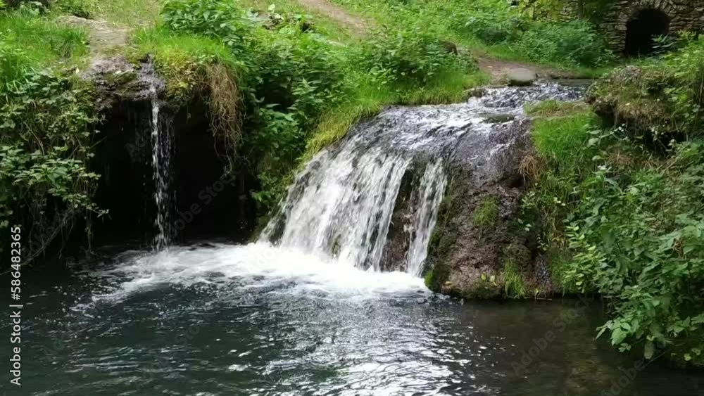 A small waterfall in the forest. Bright juicy greens and splashes of water. A quiet and peaceful place for family holidays
A small waterfall in the forest. Bright juicy greens and splashes of water. A quiet and peaceful place for family holidays