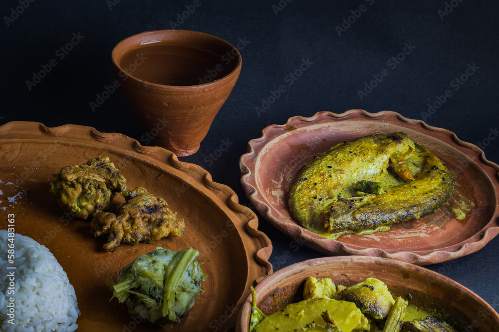 Traditional Bengali indian meal served on clay plate consisting of