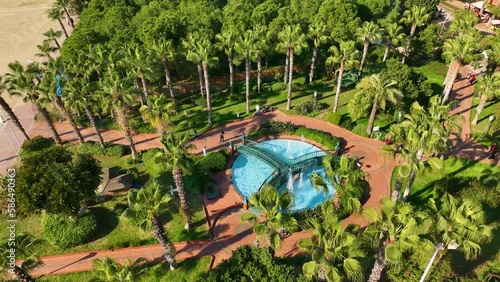 A park and a large recreation area playgrounds basketball and tennis courts fountains palm trees a beautiful beach photo