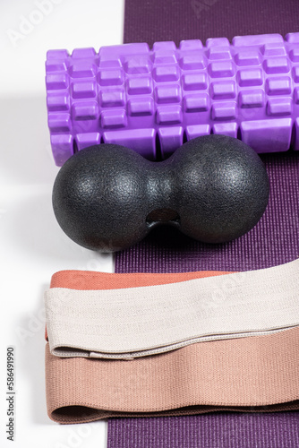 Sports equipment - massage roller, back ball and fabric fitness bands.
