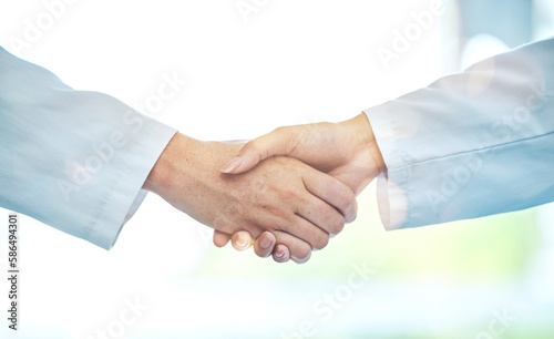 Doctor, handshake and meeting in partnership for deal, b2b or agreement in healthcare collaboration at the hospital. Medical team shaking hands in teamwork support, hiring or promotion at the clinic