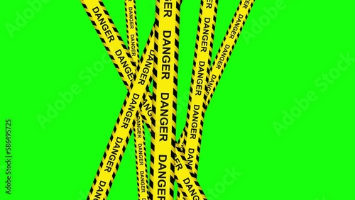 Video of a danger caution black yellow tapes stripes on chroma key background. Filmed on a isolated green screen. Trespass zone prohibited concept