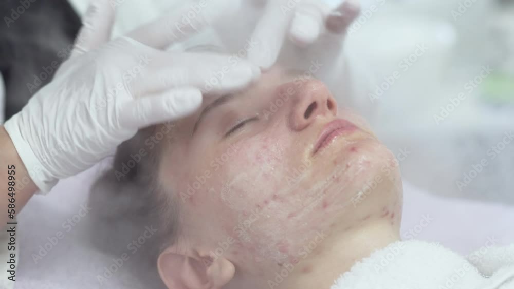 Close-up of professional facial skin care treatment with a cosmetic steamer for skin cleaning at beauty salon. Close-up of professional facial skin care treatment with a cosmetic steamer for skin cleaning at beauty salon.