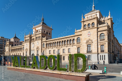 Cavalry Academy building in the center of Valladolid, In front is written the name of the city written decorated with grass an flowers. Plaza de Zorrilla Square