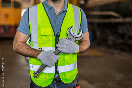 closeup male worker hand holding big wrench for fix service strong team