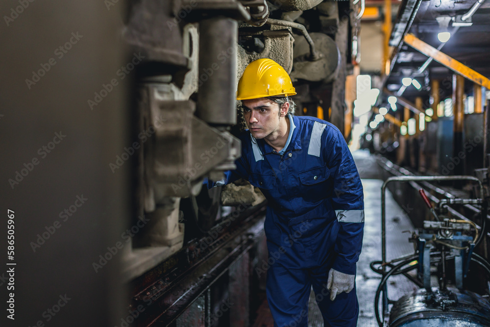 Young Engineer staff focus working service fix replace train truck at Diesel Locomotive Repair Shops Young Engineer staff focus working service fix replace train truck at Diesel Locomotive Repair Shops