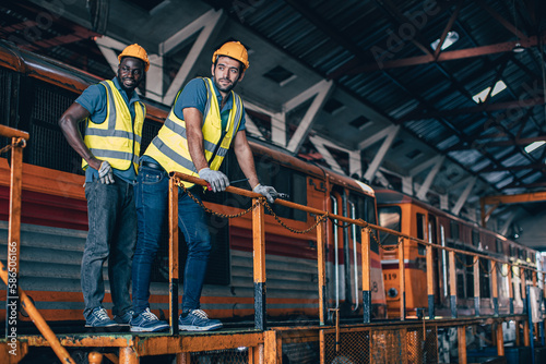 Engineer mechanic team workers standing relax in Diesel Locomotive Repair Shops © Quality Stock Arts
