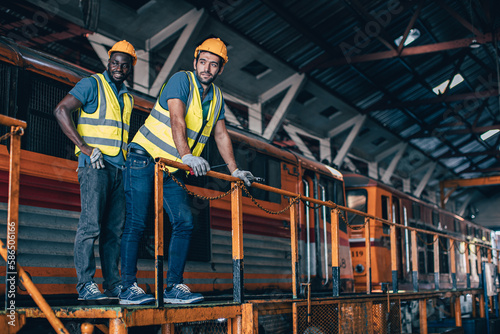 Engineer mechanic team workers standing relax in Diesel Locomotive Repair Shops