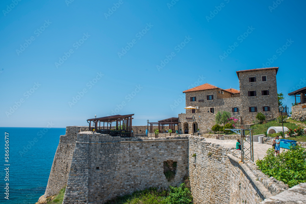 Ulcinj is also the southernmost port of Montenegro, a touristic and historical town located on the coast of the Adriatic Sea with old castle and stone made buildings with  blue sea and sky