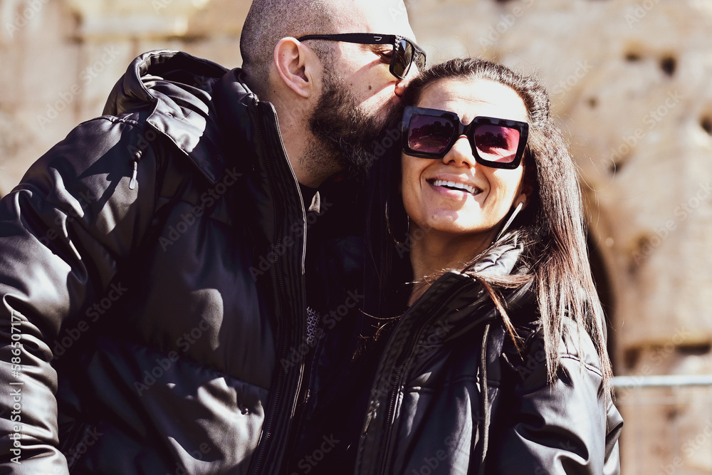 Portrait of Happy Tourists couple in love traveling at Rome, Italy, Hugging at Campidoglio Square.Concept of Italian travel. Portrait of Happy Tourists couple in love traveling at Rome, Italy, Hugging at Campidoglio Square.Concept of Italian travel.