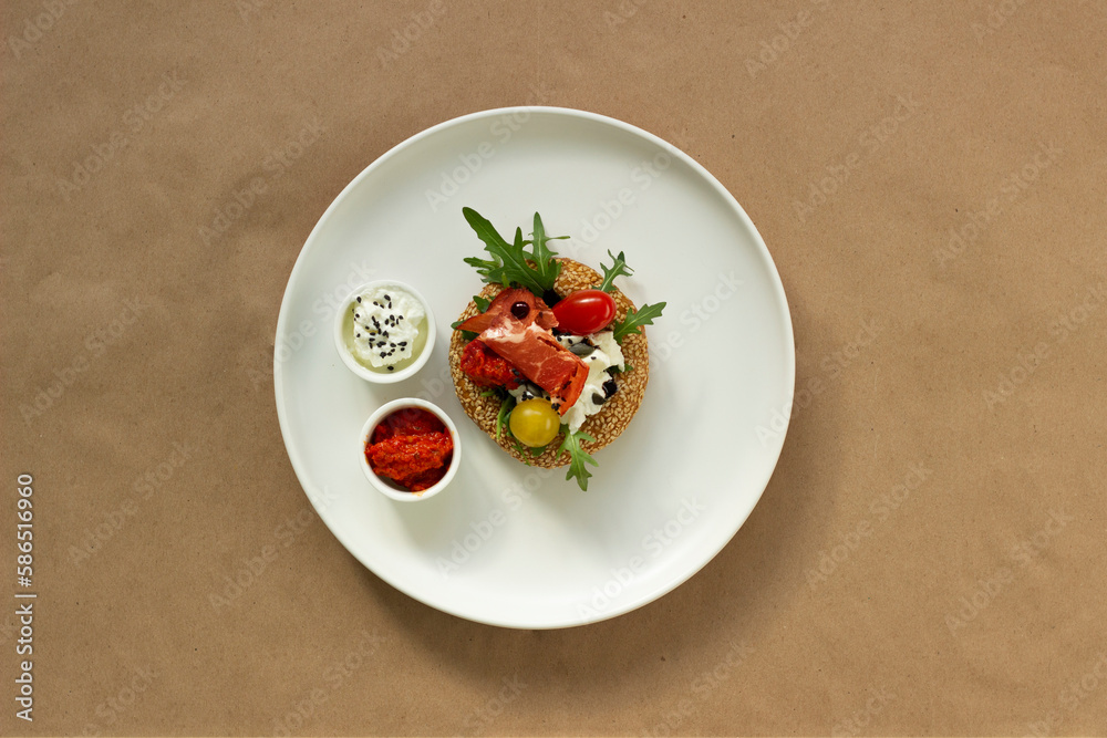 Breakfast or aperitif, arugula tomato prosciutto and tomatoes on a white plate, food concept Breakfast or aperitif, arugula tomato prosciutto and tomatoes on a white plate, food concept