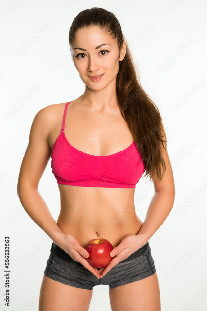 Fototapeta premium Sporty woman with an apple