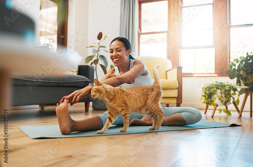 Cat, fitness or happy woman in yoga stretching legs for body flexibility, wellness or healthy lifestyle. Kitten, pet animal or zen girl in exercise, workout or training warm up in house exercising photo