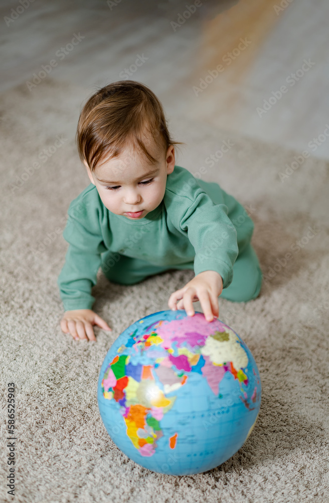 Little funny boy with globe. Child exploring the world. Concept of child education through play. Little funny boy with globe. Child exploring the world. Concept of child education through play.