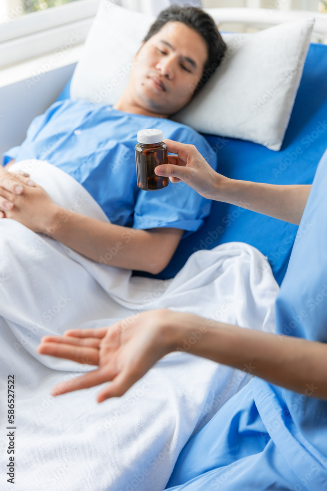 Nurse and male patient in hospital.