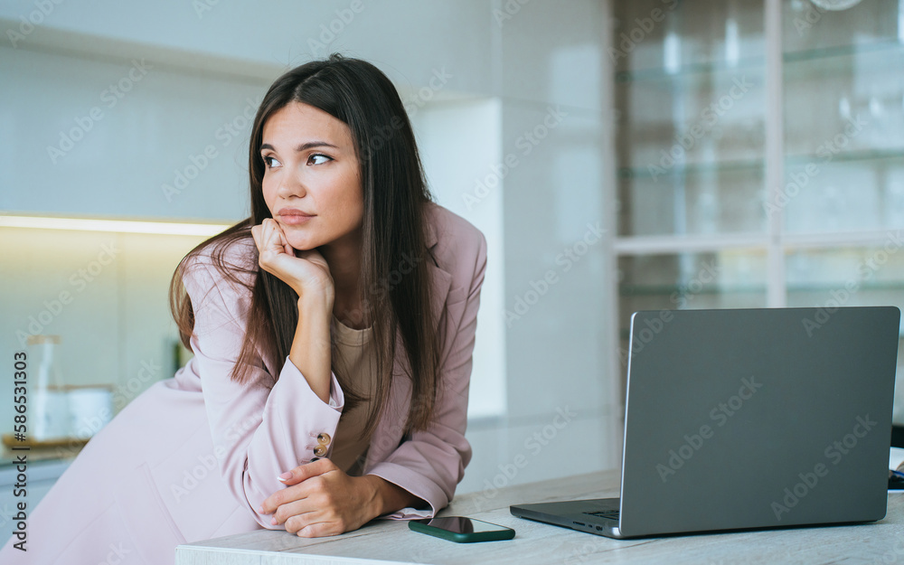 Bored Asian young businesswoman in pink suit stands at desk with laptop looks aside with tired face expression. Pensive Korean student girl feels fatigue remote works home. Financial people. Bored Asian young businesswoman in pink suit stands at desk with laptop looks aside with tired face expression. Pensive Korean student girl feels fatigue remote works home. Financial people.