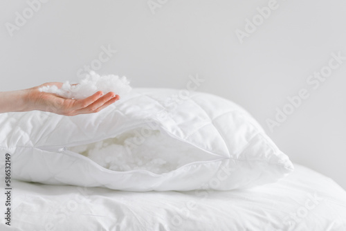 woman take cotton wool filling from cushion at home