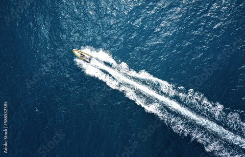 High angle view of a motorboat speeding on the ocean with copy space © rangizzz