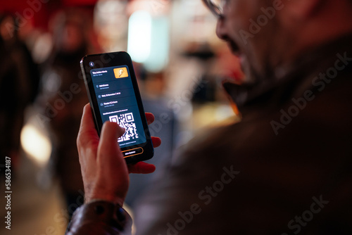 Man paying with mobile app in cinema.