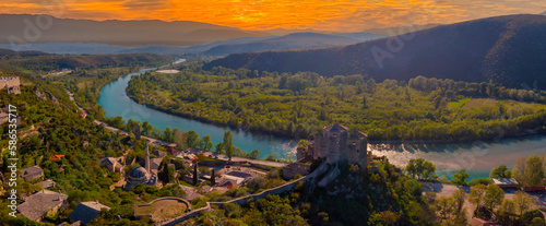 The Tower of the Kula Fort in the Historic Village of Pocitelj in Bosnia and Herzegovina, with the River Neretva photo