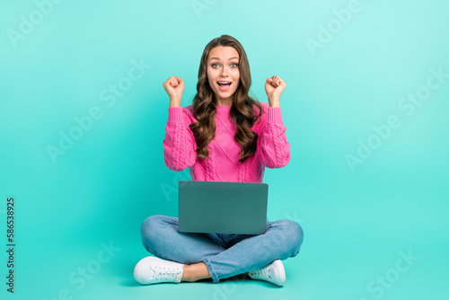 Full length photo of shiny lucky lady dressed knitted pullover winning game apple samsung device isolated teal color background