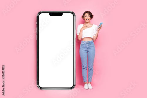 Full length photo of sweet excited lady wear white blouse communicating modern gadget empty space isolated pink color background
