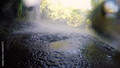 Water flowing under the waterfall. 