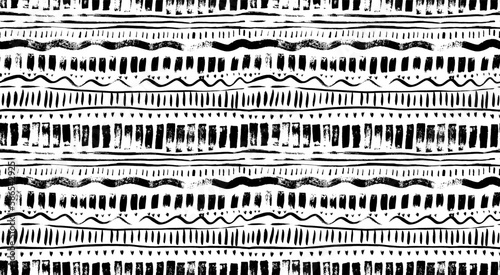 Brush drawn tribal seamless pattern. Texture with lines, dashes waves and dots. Aztec or african abstract geometric ornament. Horizontal stripes in ethnic style. Black and white vector pattern.