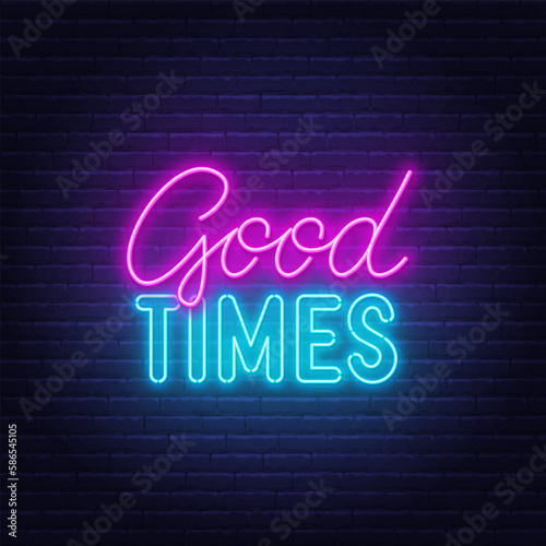 Good Times neon lettering on brick wall background.